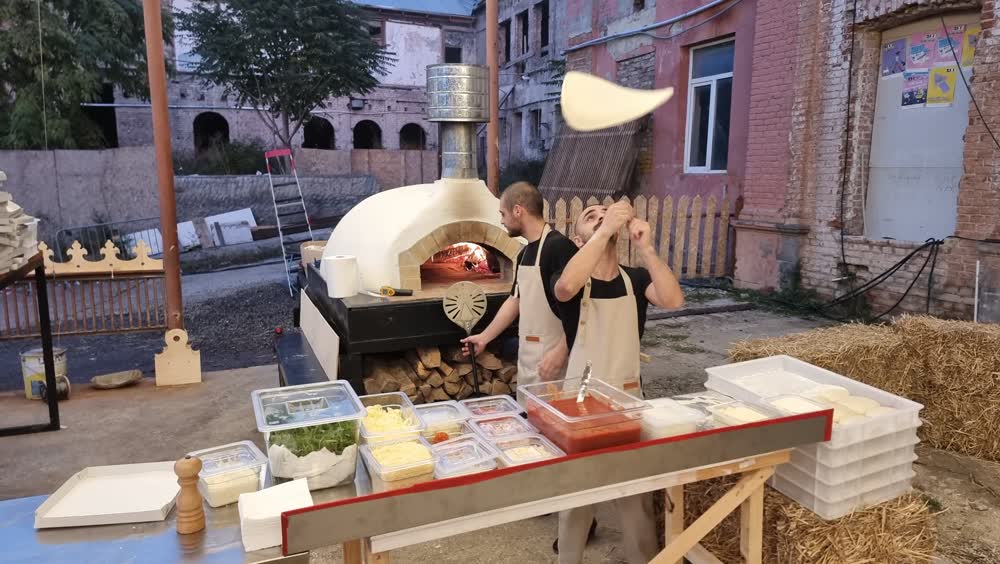 Stretching dough at an outdoor event