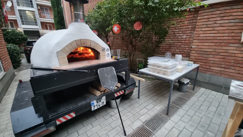 The mobile wood-fired oven, lit and ready