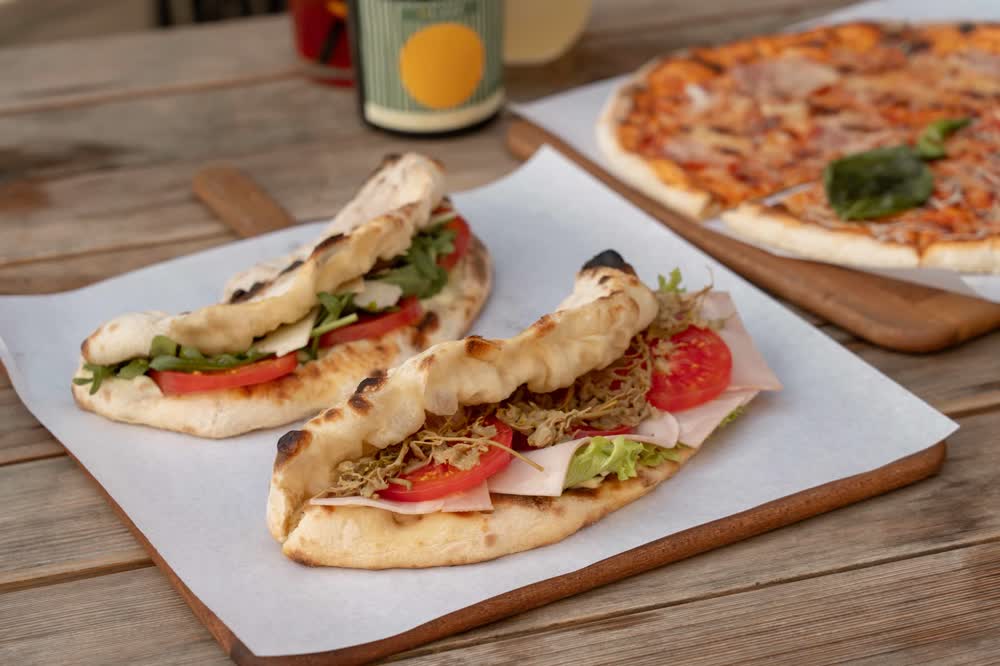 Panuozzo sandwiches and a pizza on the table
